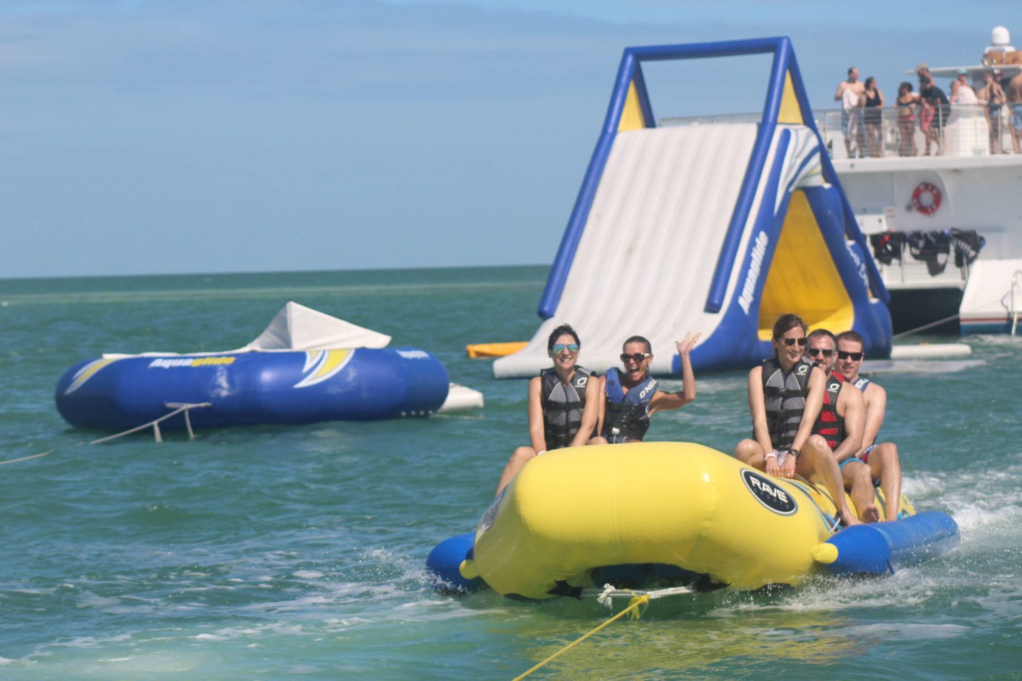 do-it-all-watersport-key-west-florida a group of people riding on the back of a boat in the water