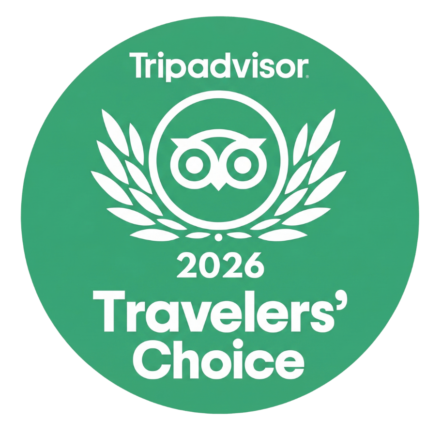 Green circle with white text: 'Tripadvisor 2026 Travelers' Choice', featuring an owl symbol.