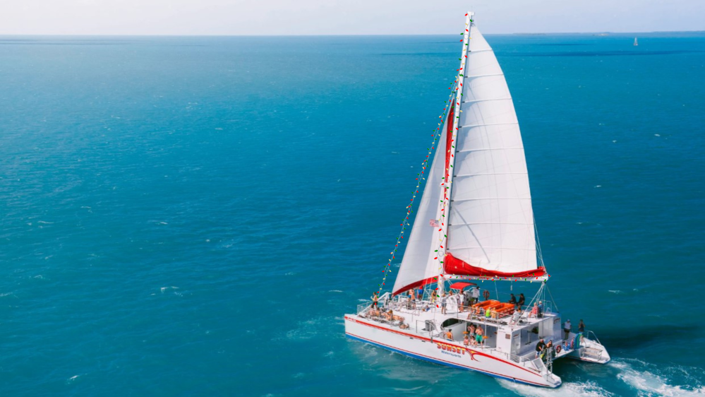Sunset Watersports Key West Sandie Cat sailing catamaran with the red-and-white "KEY WEST" sail